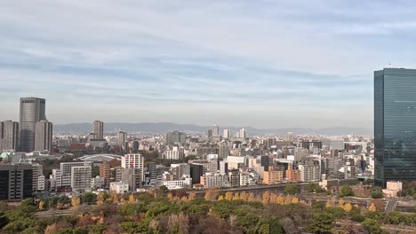 osaka city skyline with autumn leaves