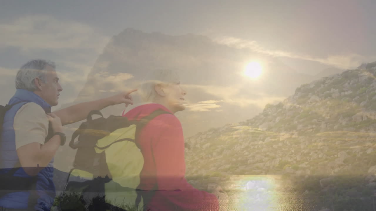 Couple hiking ridge with backpacks at sunset, with animated heart icon driving health education