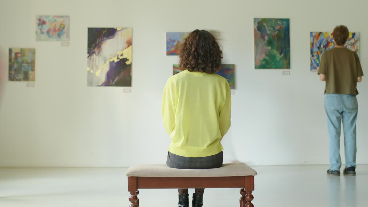 Timelapse of Woman Sitting in Art Gallery