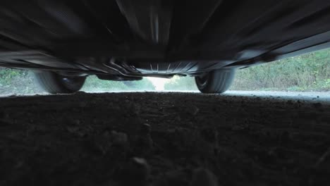 mini cooper driving down the road, shot from below, slow motion