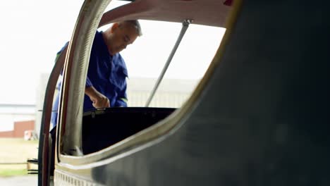 Engineer-fixing-an-aircraft-in-hangar-4k