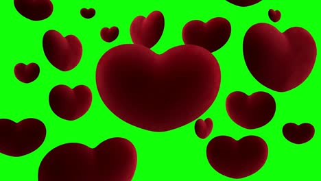 corazones de terciopelo rojo cuelgan en el aire alrededor de un gran corazón sobre un fondo verde. bucle de video