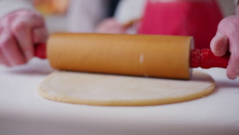 close up of rolling out pizza dough