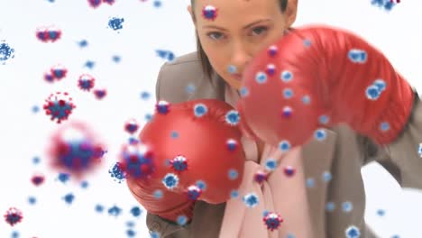 Animation-of-virus-cells-floating-over-caucasian-female-boxing