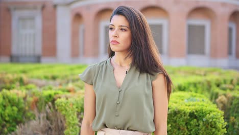 serious woman standing in a garden