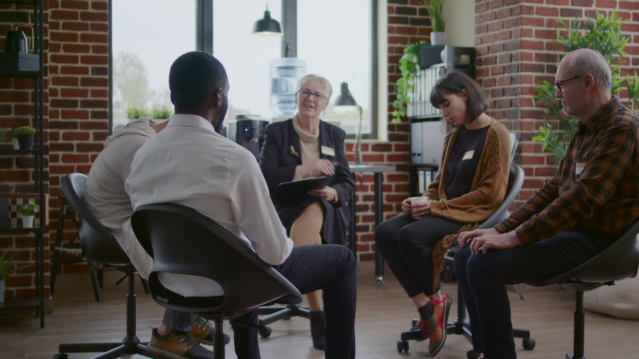 African american man talking to counselor about addiction at aa therapy meeting