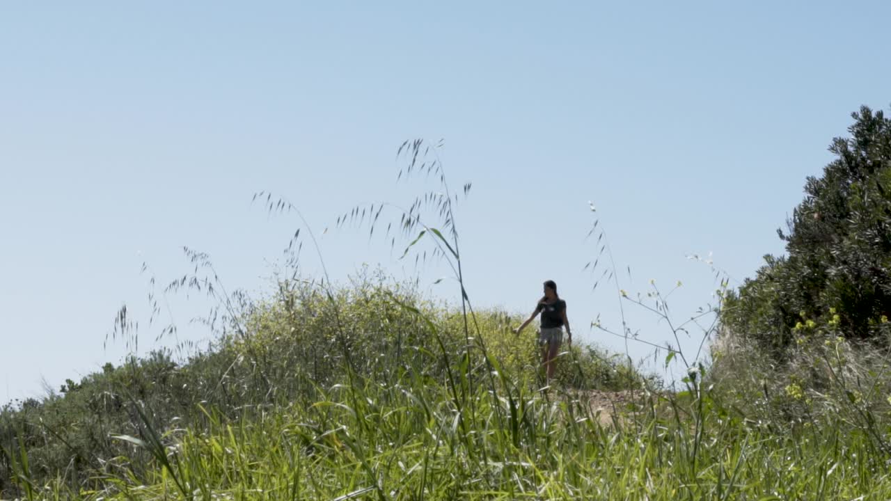 Wide shot of a girl walking in the wilderness