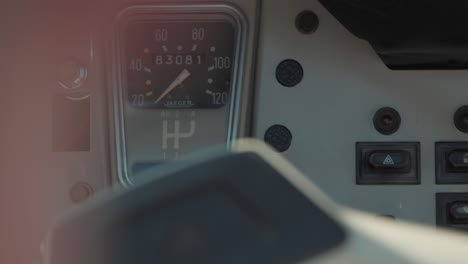 hand-held shot of a vintage deux chevaux cars odometer with someone driving