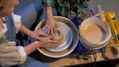 slow motion, woman works with pottery wheel in a workshop