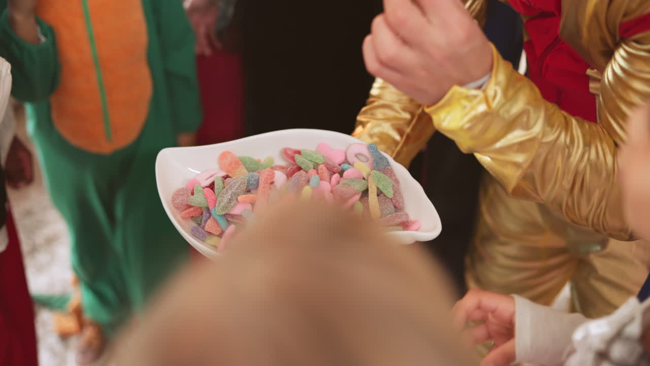 Children taking candies from a bowl