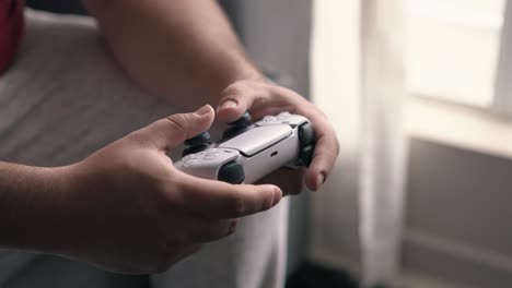 close up of hands playing modern console video game