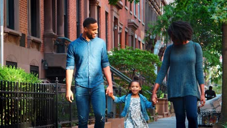 young black family walking in a brooklyn street