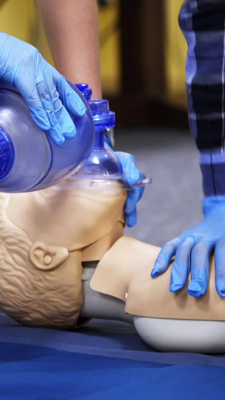 Exercise for life saving in emergency. Demonstration of CPR on manikin. Teaching method pressing on the chest on a dummy in the medical room. Vertical video
