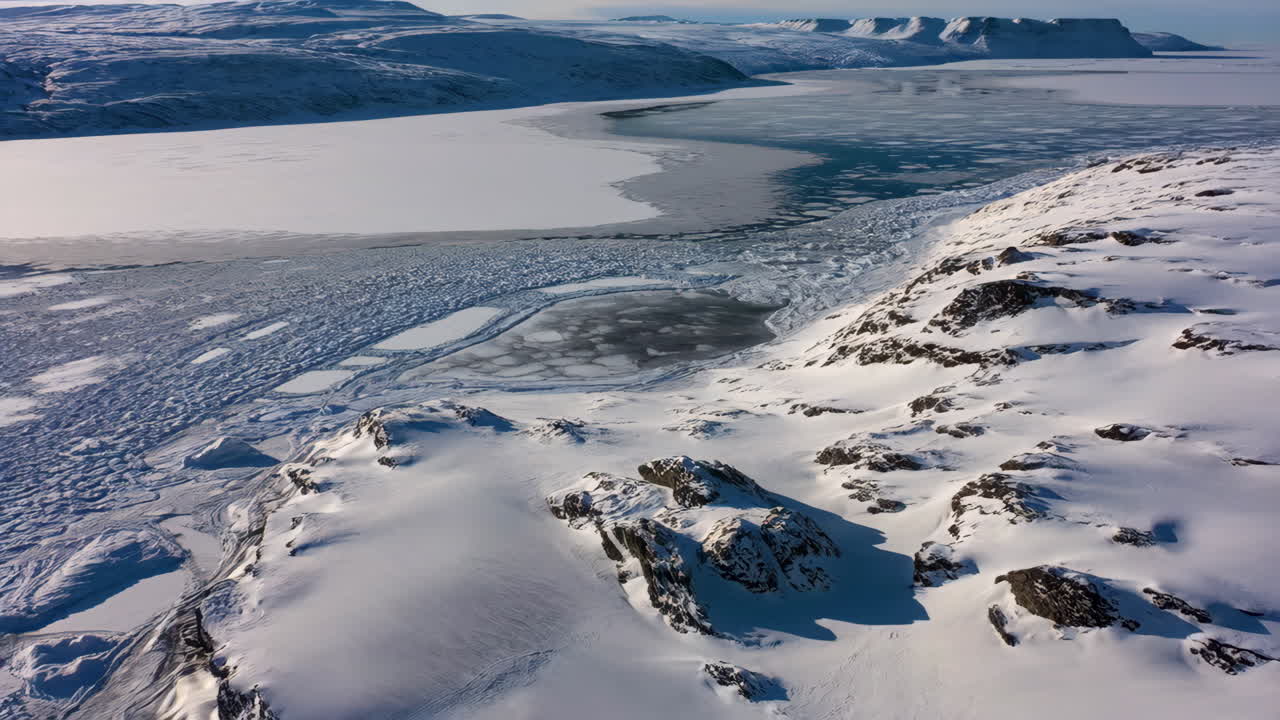 Panoramic View of Frozen Arctic Landscape with Mountains and Icy Lake
