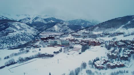 Foggy-drone-aerial-view-of-Telluride-ski-village-in-the-winter