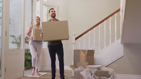 Caucasian-attractive-couple-moving-into-new-house