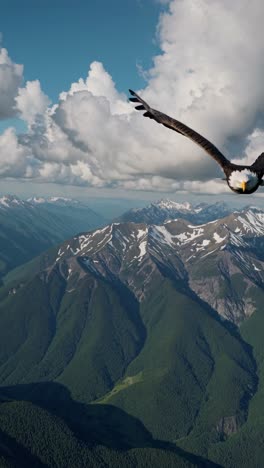 Aerial video captures a breathtaking mountain range with snow-capped peaks and lush valleys, framed