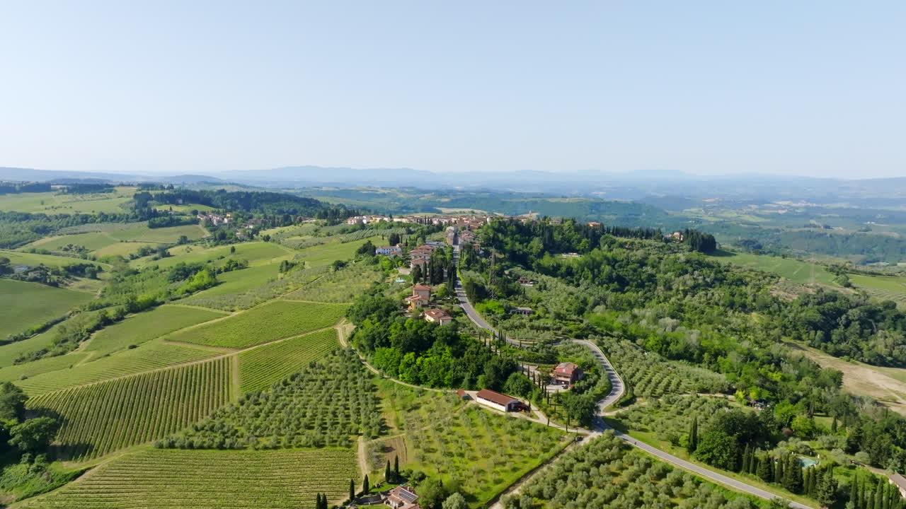 Aerial view approaching the Marcialla town, sunny, summer day in Tuscany, Italy