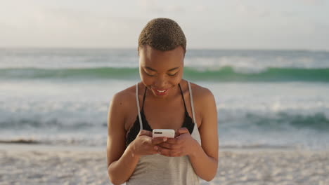 young african american woman using smartphone on beach texting browsing online messsages enjoying mobile communication at sunny seaside