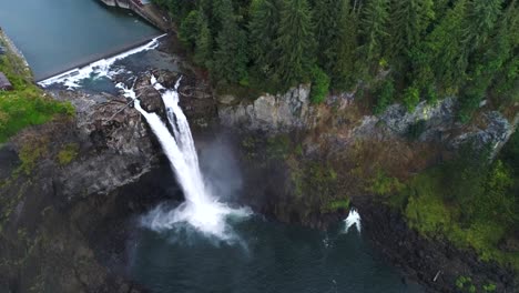 aerial of snoqualmie falls amidst a lush forest in washington state