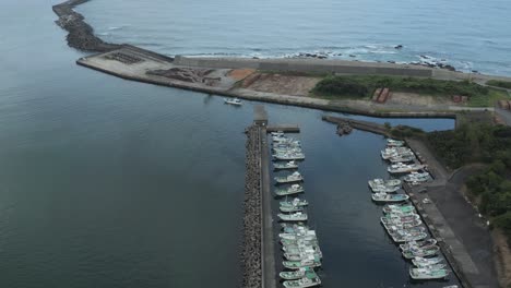 Anbo-Port-in-Yakushima-Island,-Aerial-Pan-View-of-Rural-town-on-Japanese-island