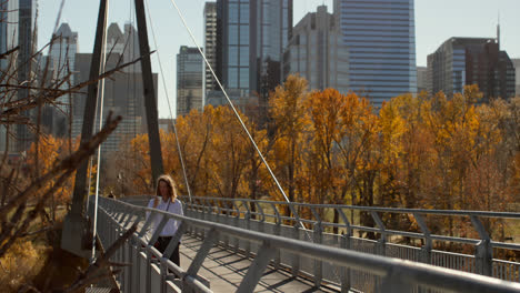 Side-view-of-young-Caucasian-man-having-coffee-on-the-bridge-in-the-city-4k