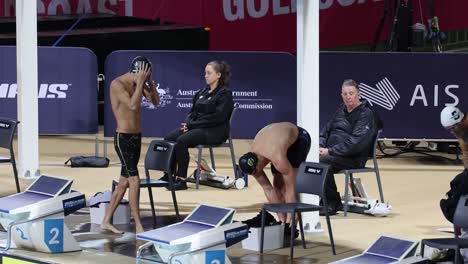 athletes readying themselves at a swimming competition