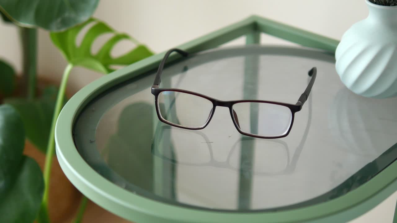 Eyeglasses Resting on a Modern Glass Side Table