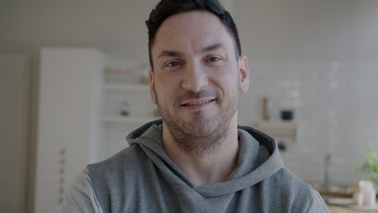 Smiling Man in a Gray Hoodie