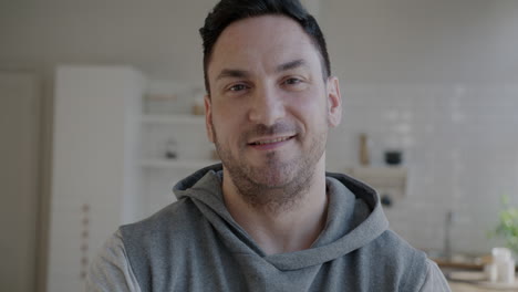 smiling man in a gray hoodie