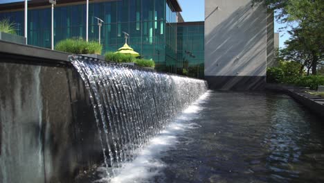 cascading waterfall over architectural structure at whitby public library in canada