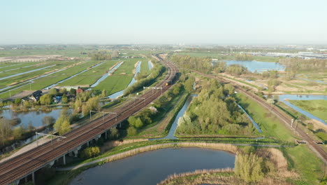 ns intercity train on the railway passing by polder in gouda, netherlands