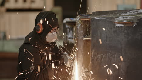 worker welding metal in a factory