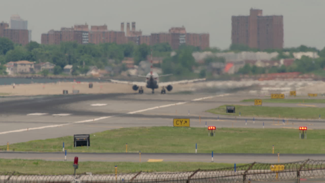 Tilt Up From Highway To Airport Runway With Plane Taking Off In Distance