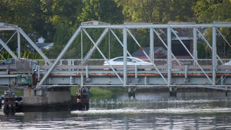 Stationary-Tight-Shot-of-Cars-Driving-Across-a-Bridge,-Light-Traffic