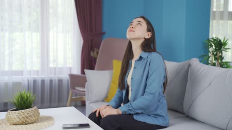 Asian-teenage-girl-praying-to-God-alone-at-home.