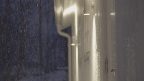 man exits home in a hurry while it is snowing outside
