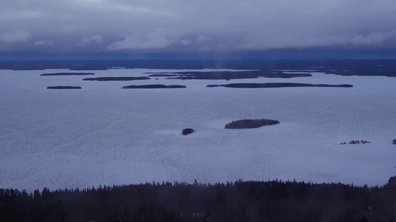 Cinematic aerial shot revealing the top of Koli mountain from Lake Pielinen