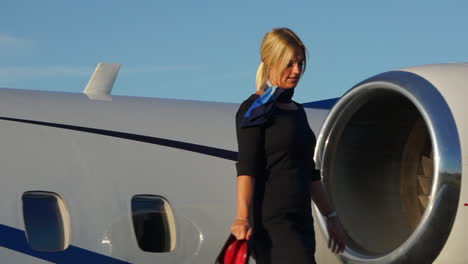 slomo: a playful flight attendant walks on the wing of an aircraft