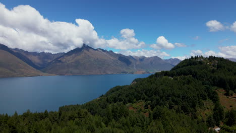 Stunning-aerial-view-of-mountains-and-forests-surrounding-lake-Hawea-in-New-Zealand