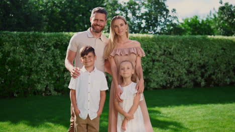 Portrait-of-happy-family-posing-outdoors