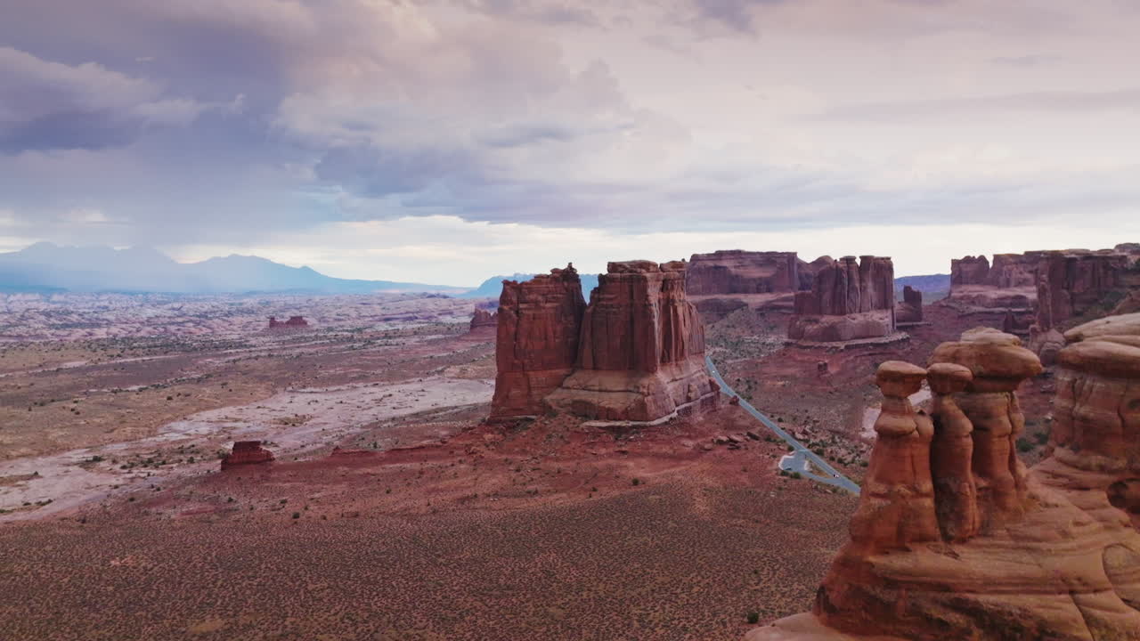 Arches national park in the cloudy daytime. Scenic view of tremendous rocks among the desert plain. Aerial view.