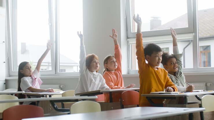 Students raising hands up.