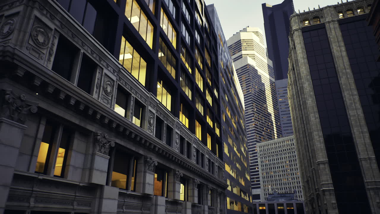 City buildings illuminated at dusk showcasing architectural variety