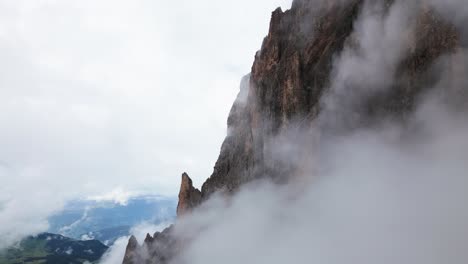 steep rock face with clouds in the mountains, dolomites, italy, europe, drone