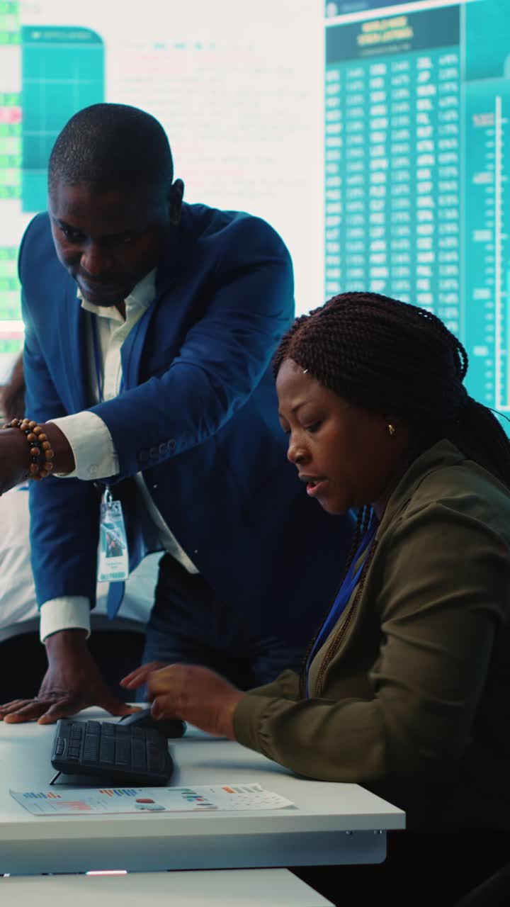 African American Business Colleagues Collaborating on Financial Data in Modern Office