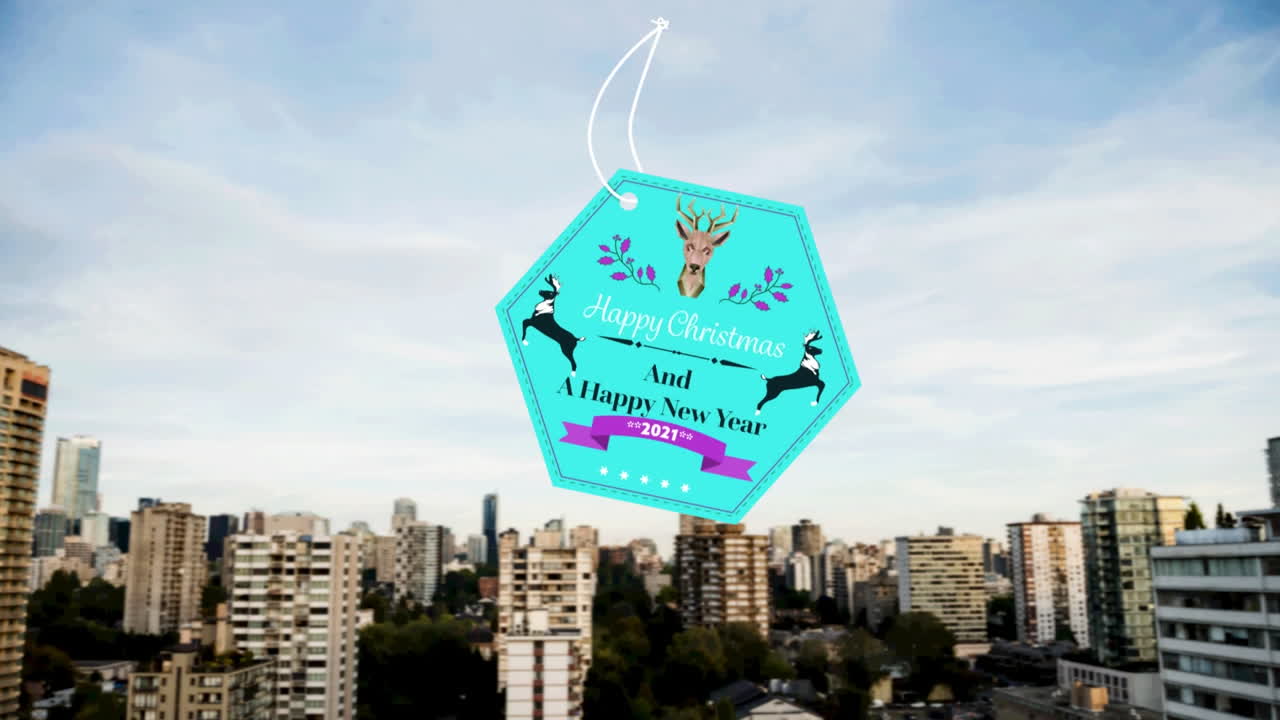 animación de felicitaciones de navidad en la etiqueta sobre el paisaje urbano en el fondo