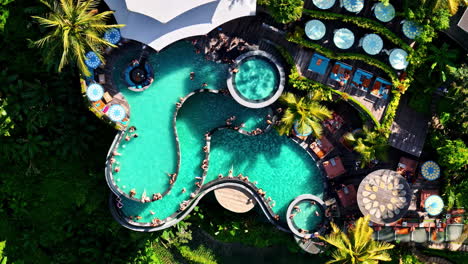 pool party in cretya luxurious club in ubud, bali. aerial top down