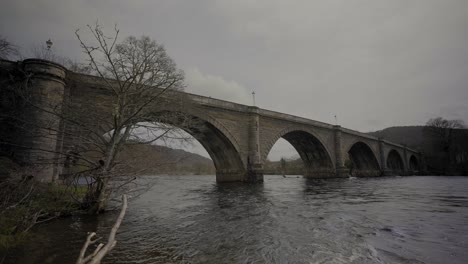 people walking on dunkeld bridge in scotland