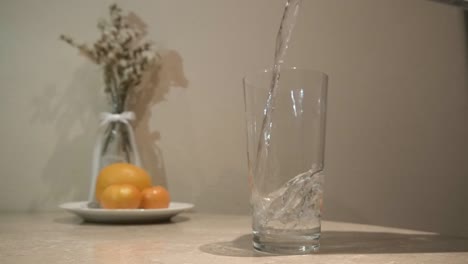 pouring clean water into glass slow motion